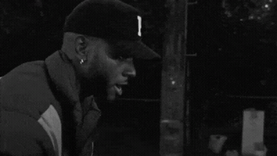 Black And White Man In Baseball Cap And Jacket GIF