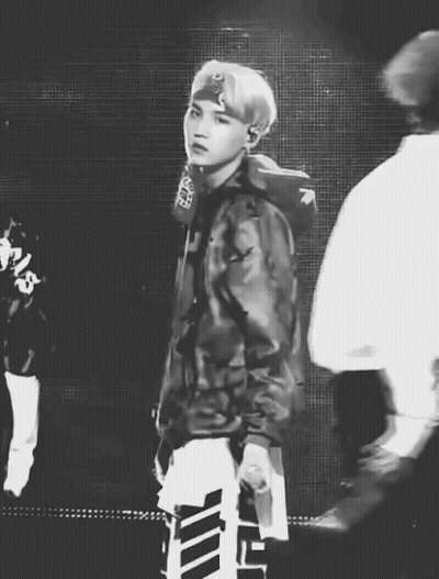 Black And White Man In Camo Jacket Holding Microphone GIF