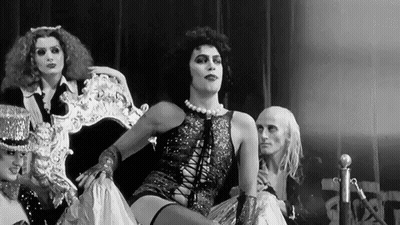 Black And White Man In Costume Sitting On Chair GIF