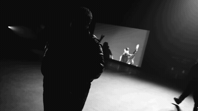 Black And White Man In Front Of Projection Screen GIF