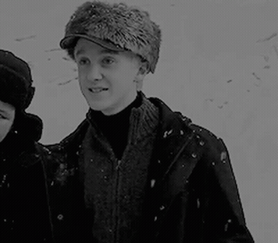 Black And White Man In Fur Hat With Woman In Snow GIF