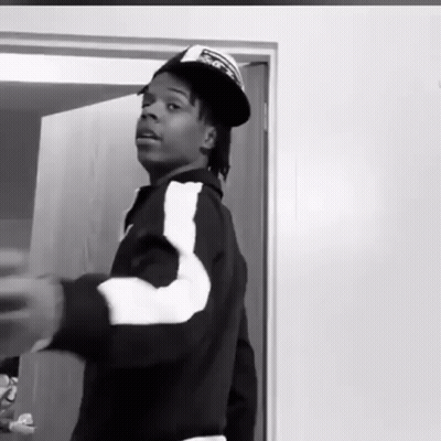 Black And White Man In Hat And Jacket Standing In Front Of Door GIF