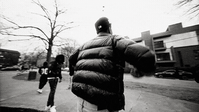 Black And White Man In Jacket Hat Walking GIF