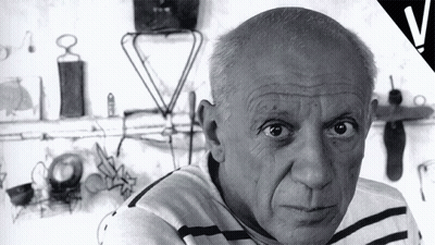 Black And White Man In Striped Shirt Looking At Camera GIF