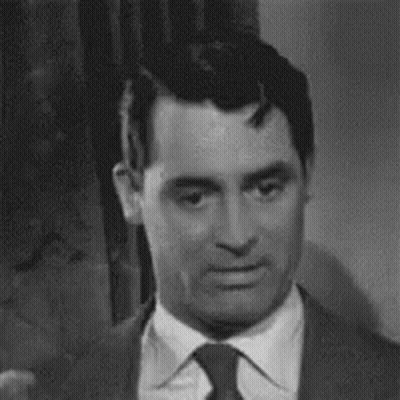 Black And White Man In Suit And Tie Looking At Camera GIF