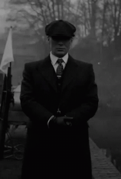 Black And White Man In Suit Holding Gun GIF