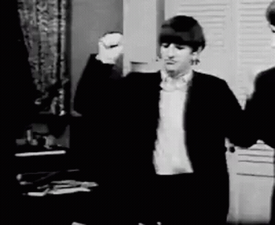 Black And White Man In Suit Raising Fist GIF