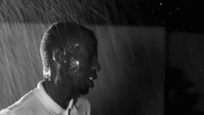 Black And White Man In White Shirt In Rain GIF