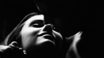 Black And White Man Kissing Woman On Cheek GIF