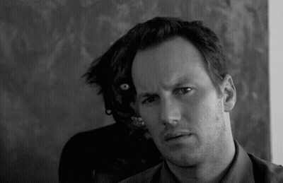 Black And White Man Looking At Camera With Monster Behind GIF