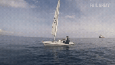 Black And White Man On Pier Next To Sailboat GIF