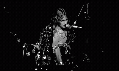 Black And White Man Playing Drums On Stage GIF