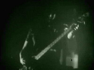 Black And White Man Playing Guitar In Dark Room GIF