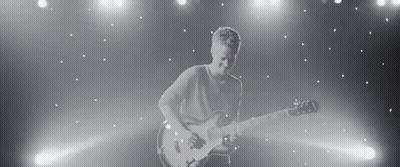 Black And White Man Playing Guitar On Stage GIF