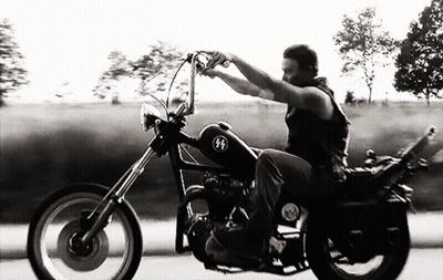Black And White Man Riding Motorcycle With SS Logo GIF