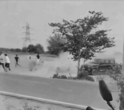 Black And White Man Running Towards Car On Road GIF