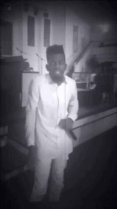 Black And White Man Singing Into Microphone In Church GIF