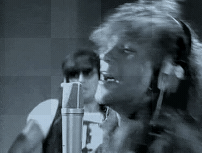 Black And White Man Singing Into Microphone In Recording Studio GIF