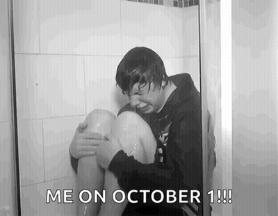 Black And White Man Sitting In Shower With Knee In Water GIF