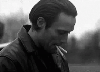 Black And White Man Smoking Cigarette In Leather Jacket GIF
