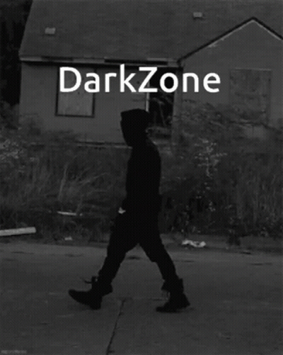 Black And White Man Standing In Front Of Darkzone Building GIF