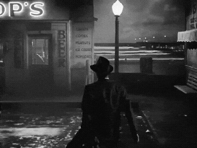 Black and White Man Walking Past Op's Shop