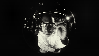 Black and White Man With Glasses Looking Down