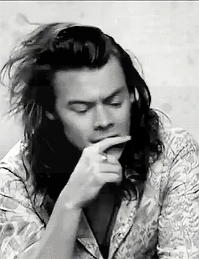 Black And White Man With Long Hair Hand To Mouth GIF