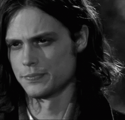 Black And White Man With Long Hair Looking At Camera GIF