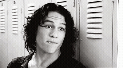 Black And White Man With Long Hair Next To Lockers GIF
