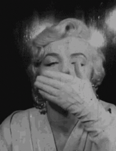 Black And White Marilyn Monroe Covering Mouth With Hand GIF
