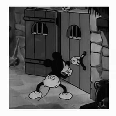 Black And White Mickey Mouse Standing Next To Door GIF