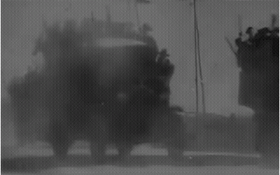 Black And White Military Vehicle On Dirt Road GIF