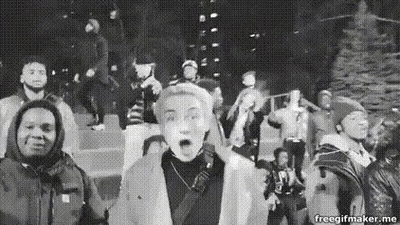 Black And White People Standing Around Christmas Tree GIF