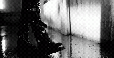 Black And White Person In Black Boots Walking In Rain GIF