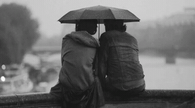 Black and White Person on Rainy Bench with Visa Umbrella