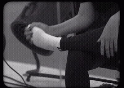Black And White Person Putting On White Socks GIF