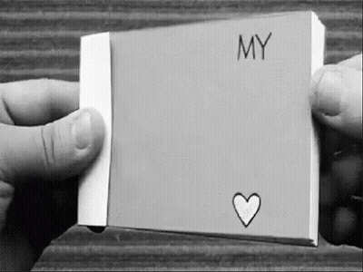 Black And White Photo Holding Paper With Heart GIF