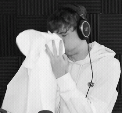 Black And White Photo Man In Headphones Kissing Another Man GIF