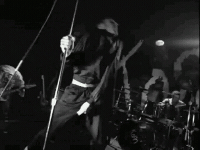Black And White Photo Of Band Playing Concert GIF