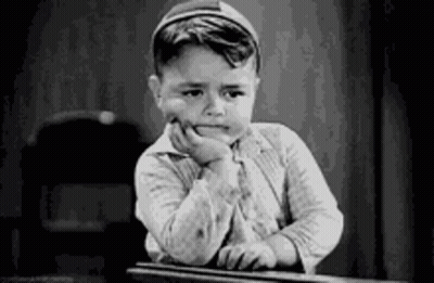 Black and White Photo of Boy at Desk