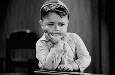 Black And White Photo Of Boy With Hand On Chin GIF