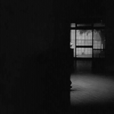 Black And White Photo Of Couple Dancing In Dark Room GIF