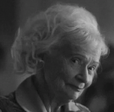 Black And White Photo Of Elderly Woman With Curly Hair GIF