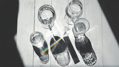 Black And White Photo Of Glasses Of Water And A Prism GIF