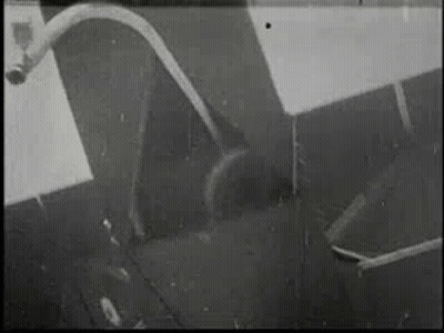 Black And White Photo Of Hose Coming Out Of Pipe On Wall GIF