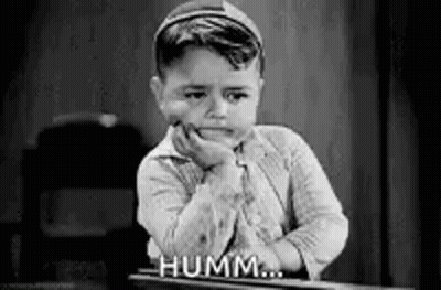 Black And White Photo Of Little Boy With Hand On Face GIF
