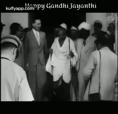 Black And White Photo Of Mahatma Gandhi Walking Through Crowd GIF