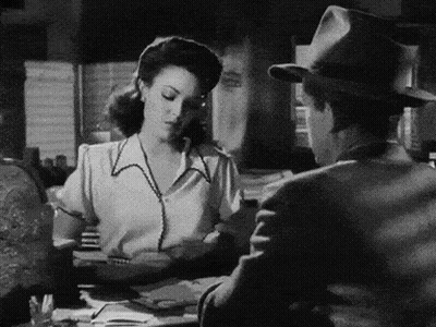 Black And White Photo Of Man And Woman At Table GIF