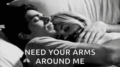 Black And White Photo Of Man And Woman Hugging In Bed GIF